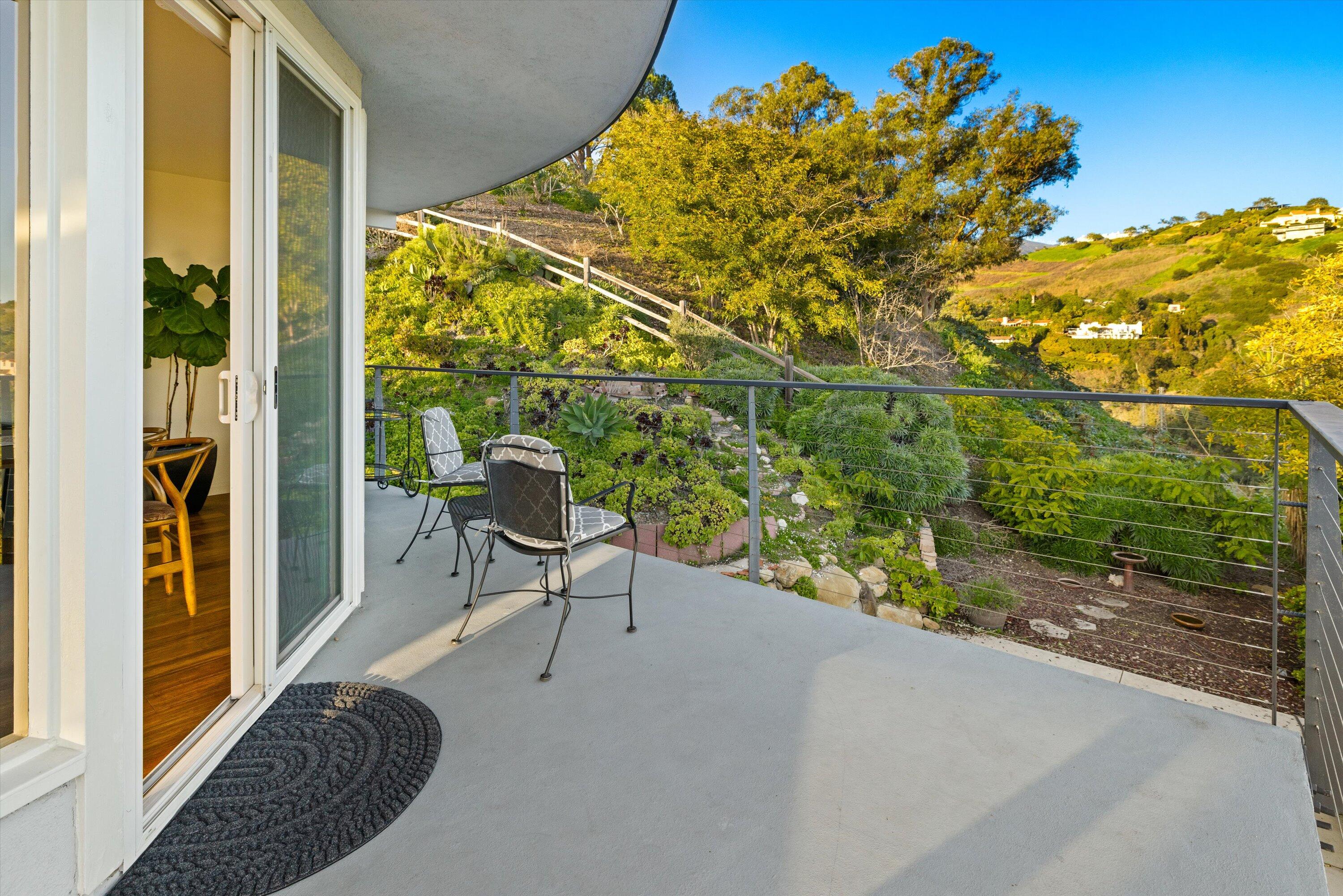 128 Las Alturas Road Santa Barbara, CA 93103 - Photo 12 of 36 a view of a porch with furniture and a gate