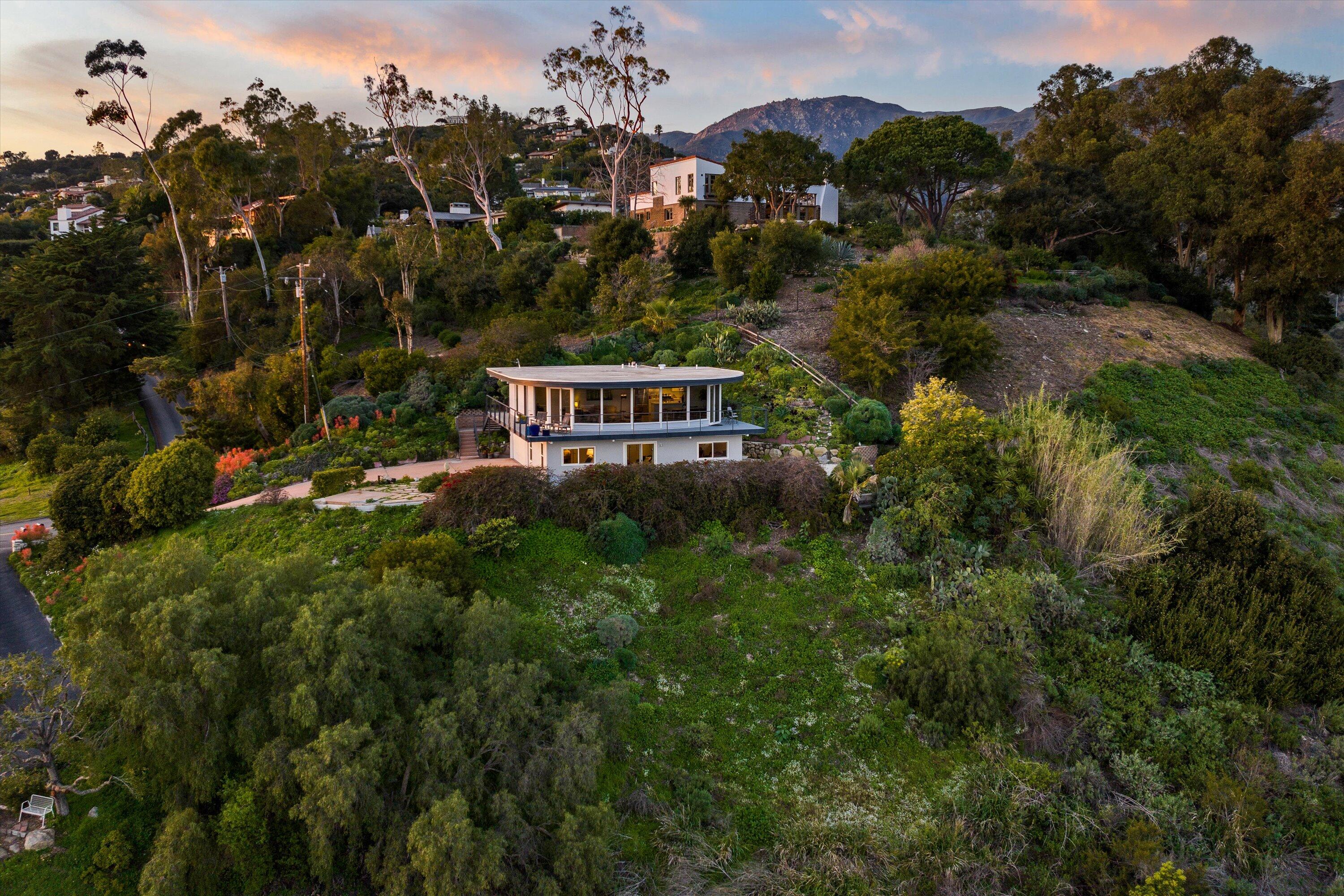 128 Las Alturas Road Santa Barbara, CA 93103 - Photo 13 of 36 a view of a house with a yard and potted plants