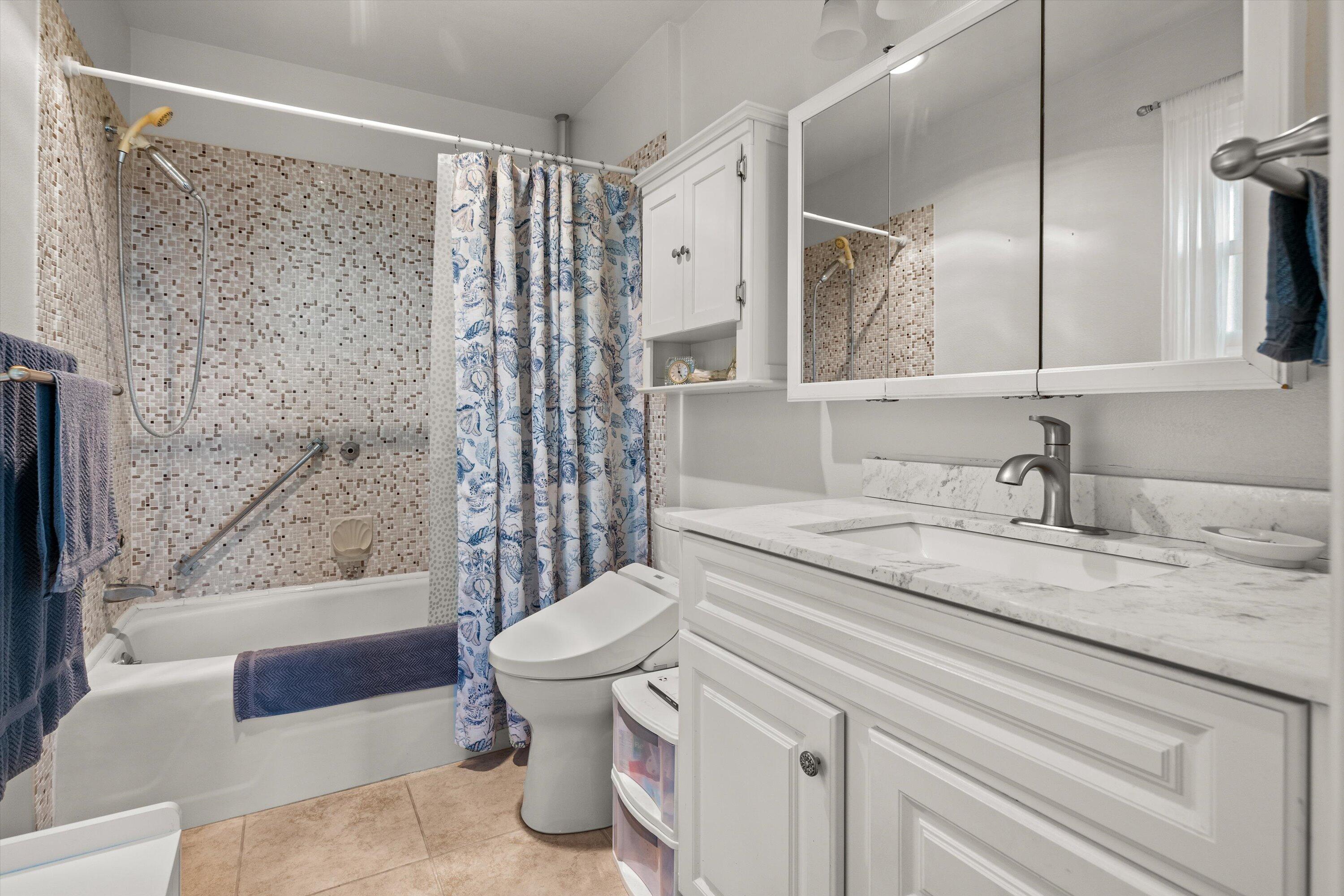 128 Las Alturas Road Santa Barbara, CA 93103 - Photo 22 of 36 a bathroom with a granite countertop sink toilet and shower