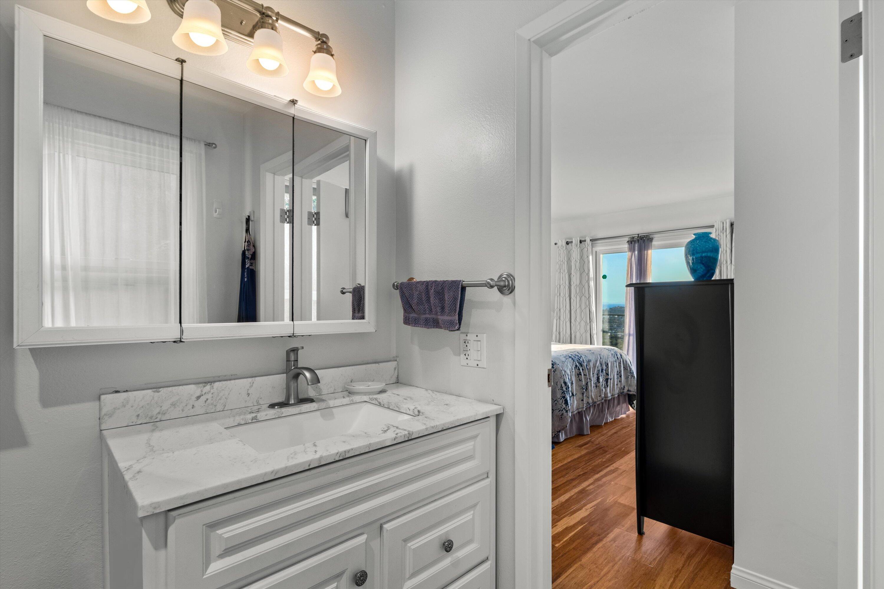 128 Las Alturas Road Santa Barbara, CA 93103 - Photo 23 of 36 a bathroom with a granite countertop sink and a mirror