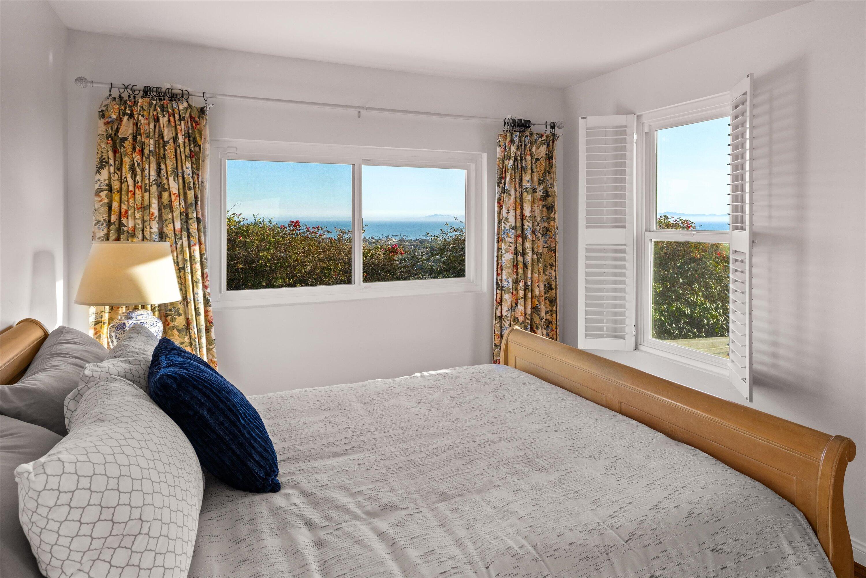 128 Las Alturas Road Santa Barbara, CA 93103 - Photo 27 of 36 a bedroom with a large bed and a large window