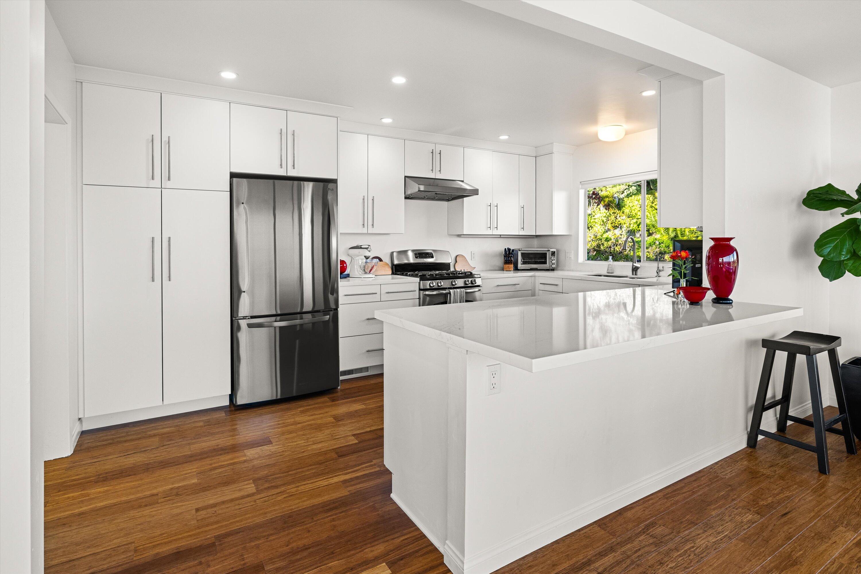 128 Las Alturas Road Santa Barbara, CA 93103 - Photo 7 of 36 a kitchen with a refrigerator a sink and a stove