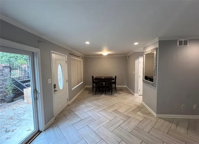 a view of a hallway with furniture and front door