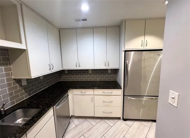 a kitchen with a refrigerator and a sink