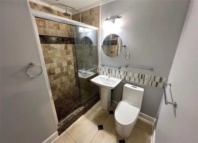 a bathroom with a sink toilet and shower