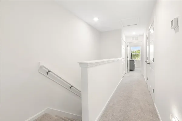 a view of a hallway with white walls