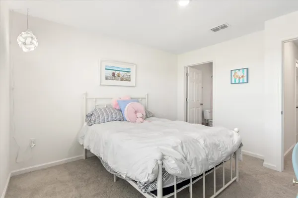 a bedroom with a bed and a lamp