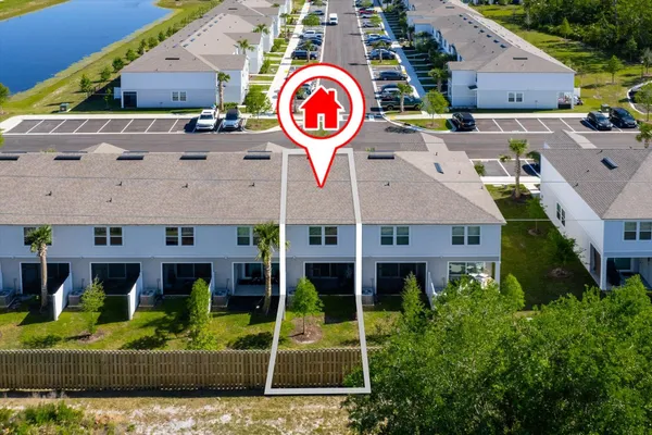 an aerial view of a house with garden space and street view