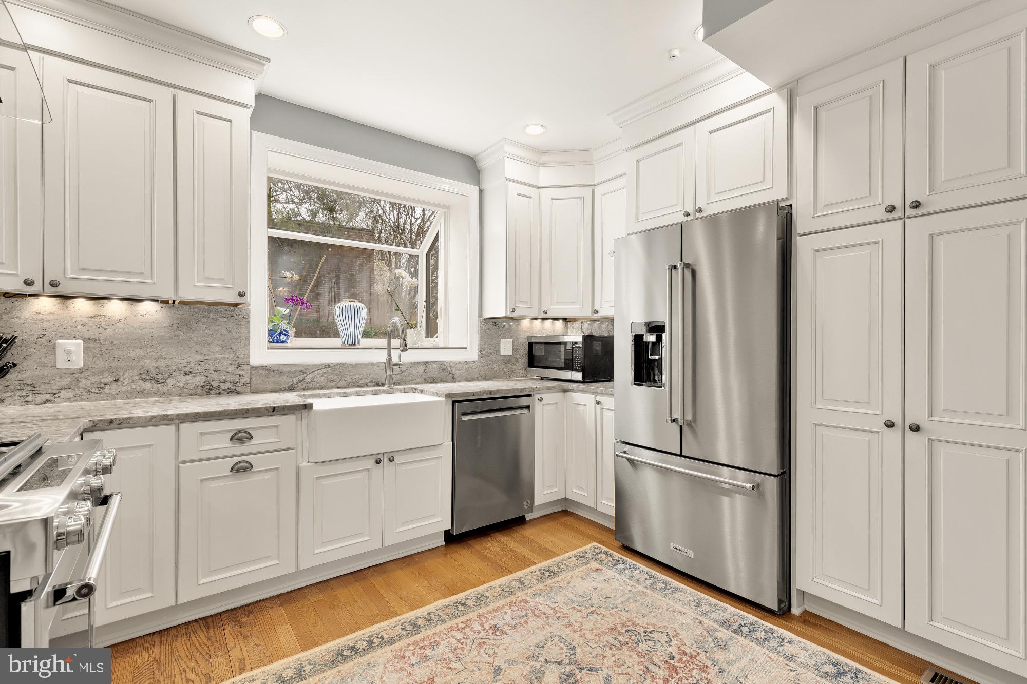 4109 17th Street Northwest Washington, DC 20011 - Photo 15 of 47 a kitchen with white cabinets and white appliances