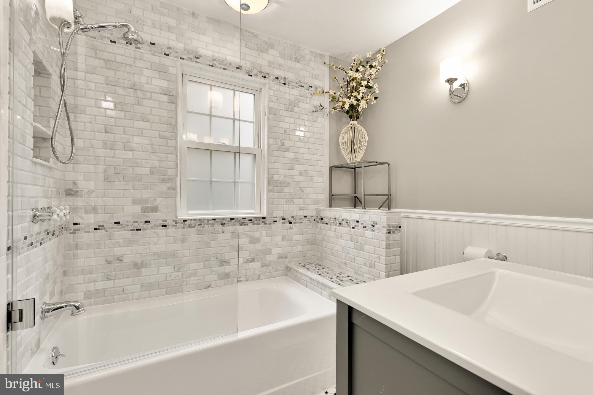 4109 17th Street Northwest Washington, DC 20011 - Photo 29 of 47 a bathroom with a sink a mirror and a bathtub