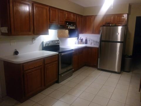 a kitchen with stainless steel appliances granite countertop a refrigerator and a stove