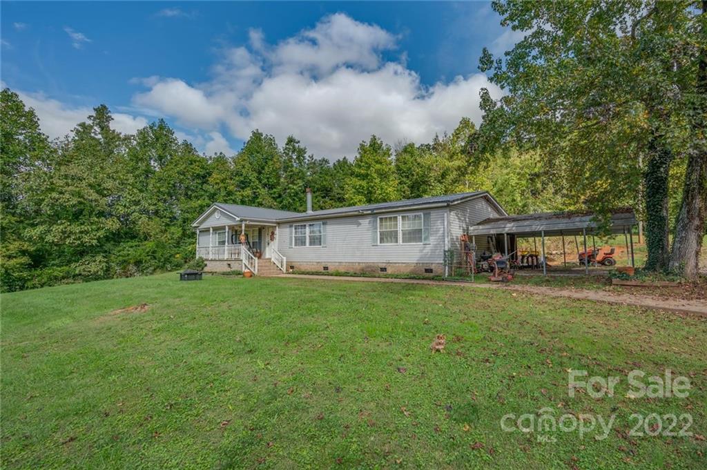 280 Highway 9 Mill Spring, NC 28756 - Photo 1 of 18 a house view with a garden space