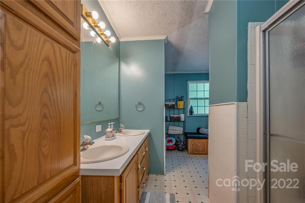 280 Highway 9 Mill Spring, NC 28756 - Photo 11 of 18 a bathroom with a sink and a mirror