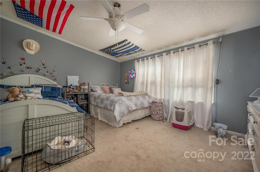 280 Highway 9 Mill Spring, NC 28756 - Photo 13 of 18 a bedroom with bed and a window