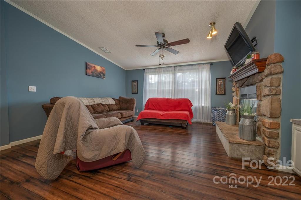 280 Highway 9 Mill Spring, NC 28756 - Photo 3 of 18 a living room with furniture and a flat screen tv
