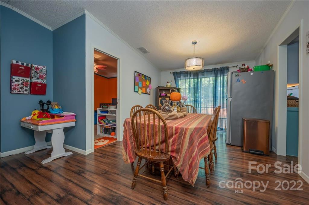 280 Highway 9 Mill Spring, NC 28756 - Photo 5 of 18 a view of a dining room with furniture window and wooden floor