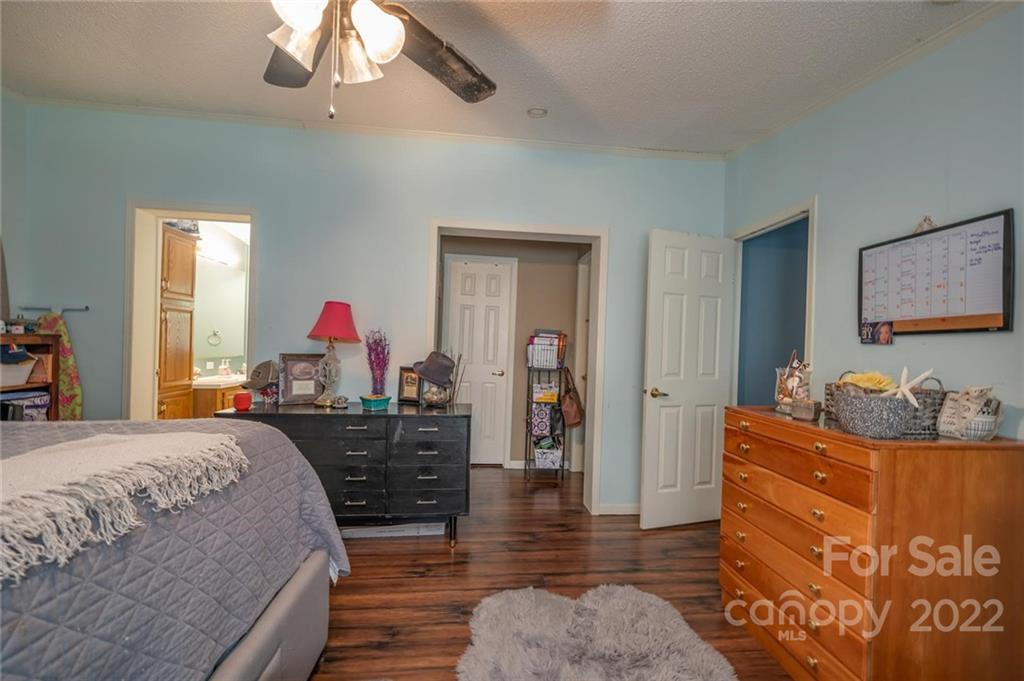 280 Highway 9 Mill Spring, NC 28756 - Photo 9 of 18 a bed room with bed and mirror
