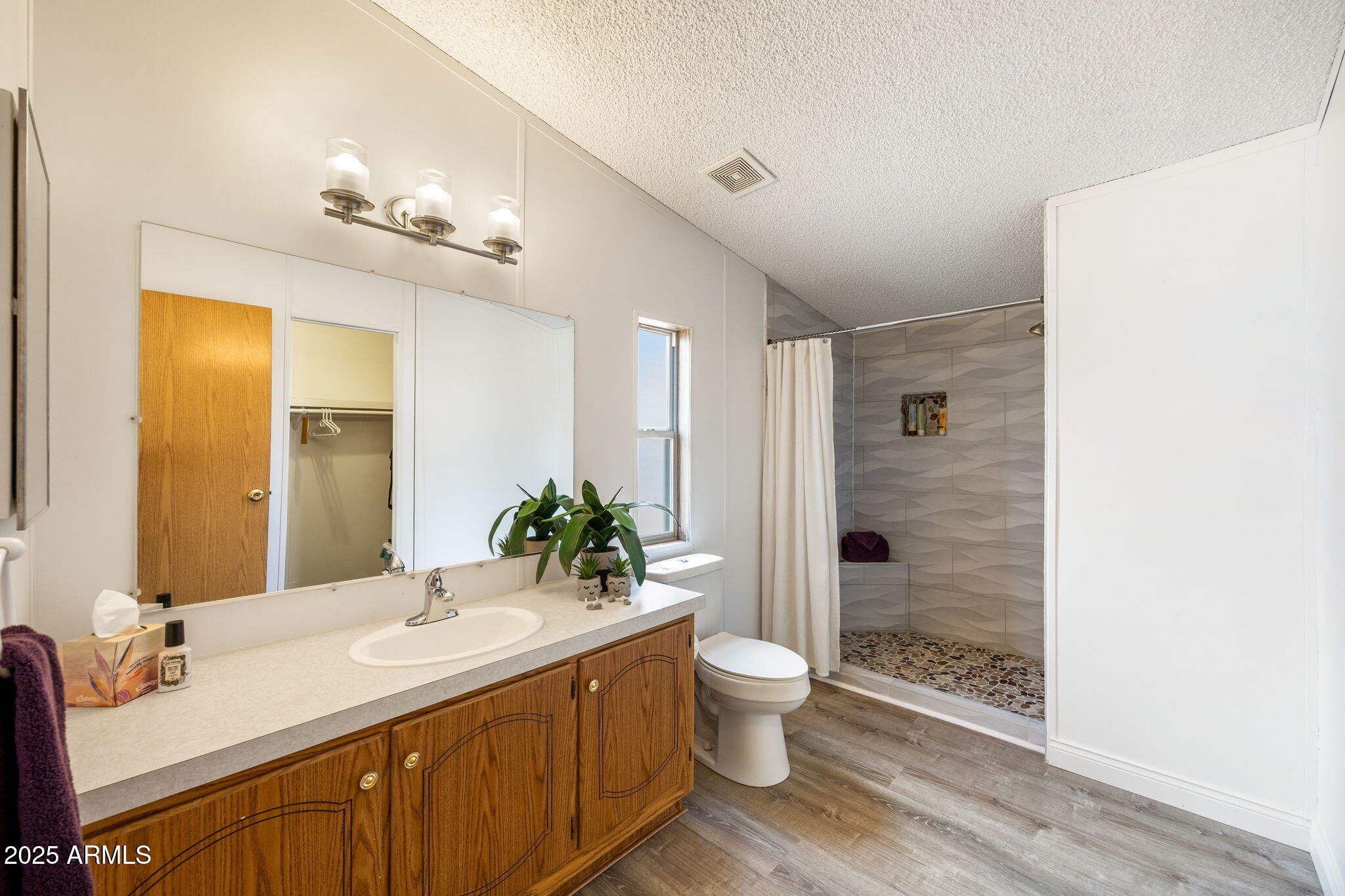 2064 Pinewood Drive Overgaard, AZ 85933 - Photo 13 of 33 a bathroom with a double vanity sink toilet and shower