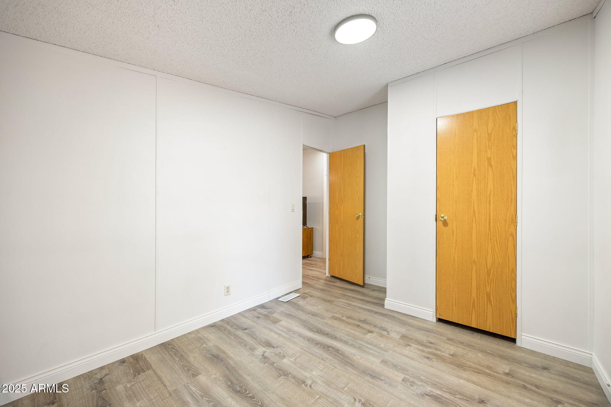 2064 Pinewood Drive Overgaard, AZ 85933 - Photo 15 of 33 a view of an empty room with wooden floor and closet