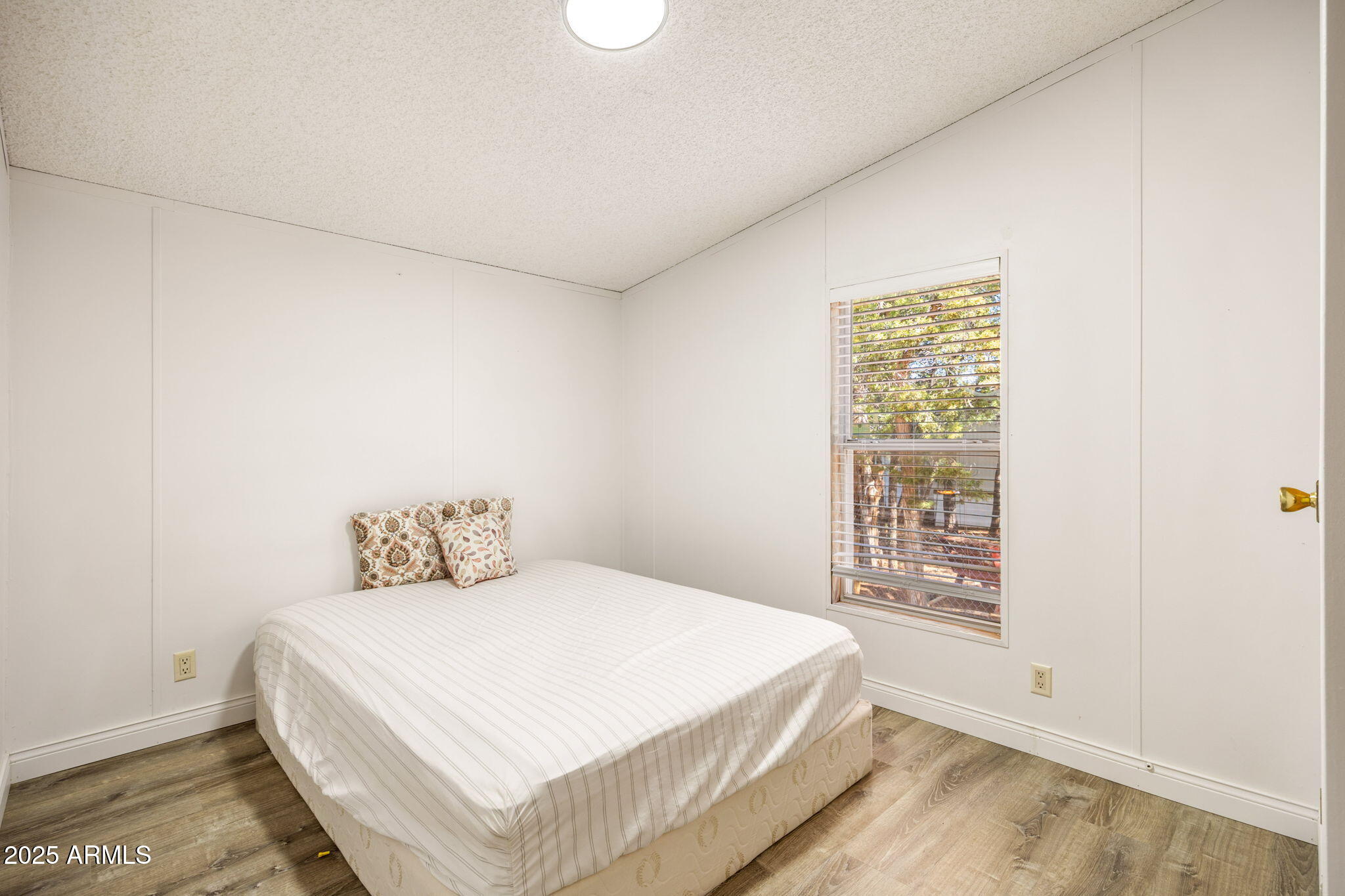 2064 Pinewood Drive Overgaard, AZ 85933 - Photo 19 of 33 a bedroom with a bed and a window