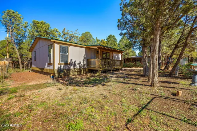 a view of a house with a yard covered in snow