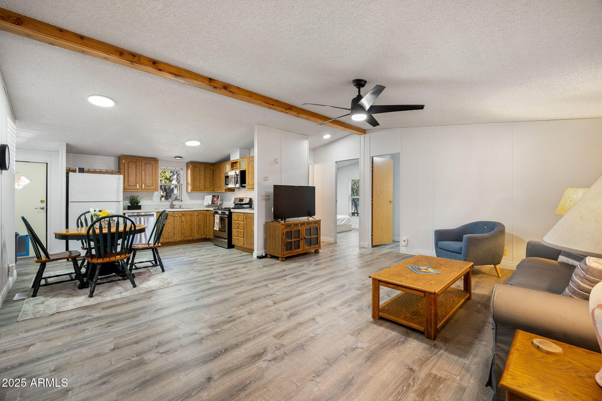 2064 Pinewood Drive Overgaard, AZ 85933 - Photo 6 of 33 a living room with furniture and a flat screen tv with kitchen view