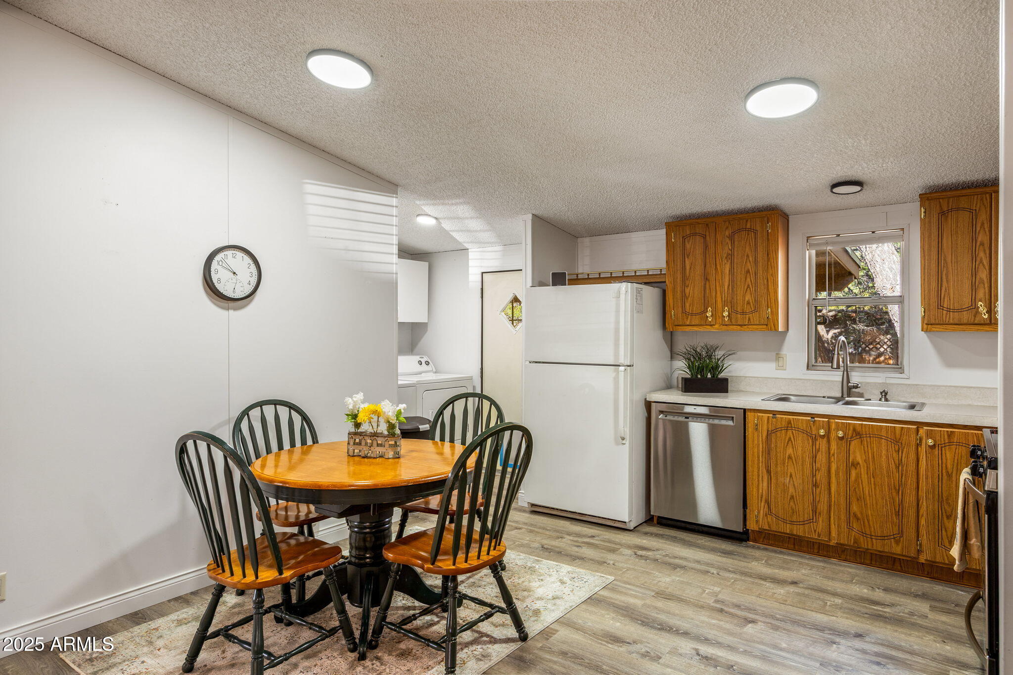 2064 Pinewood Drive Overgaard, AZ 85933 - Photo 9 of 33 a kitchen with stainless steel appliances a dining table chairs and refrigerator