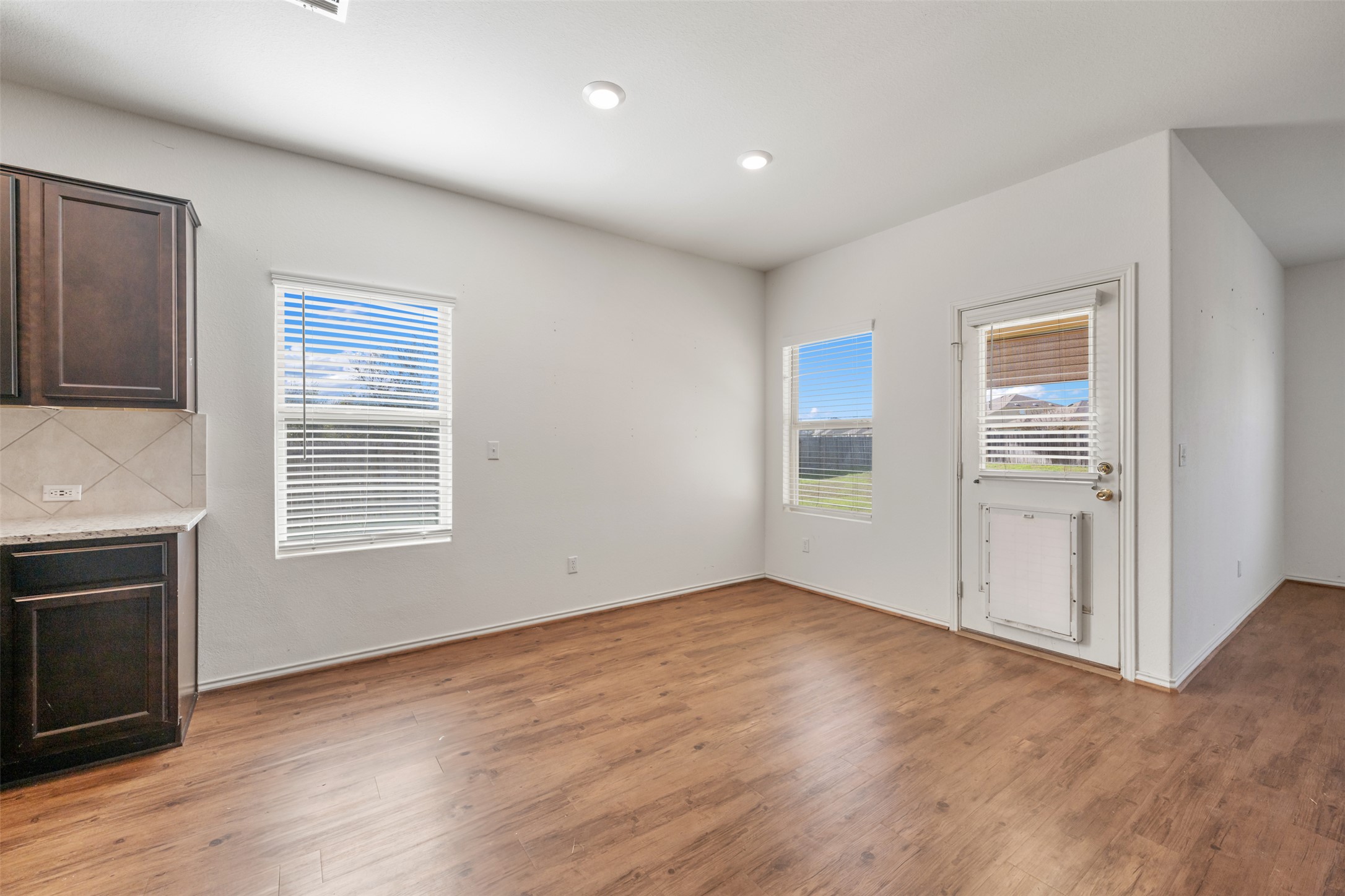 160 Copper Lane Kyle, TX 78640 - Photo 17 of 40 a view of an empty room with wooden floor and a window