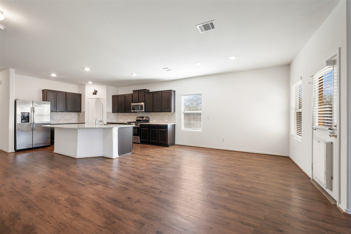 160 Copper Lane Kyle, TX 78640 - Photo 18 of 40 a view of kitchen with wooden floor and electronic appliances