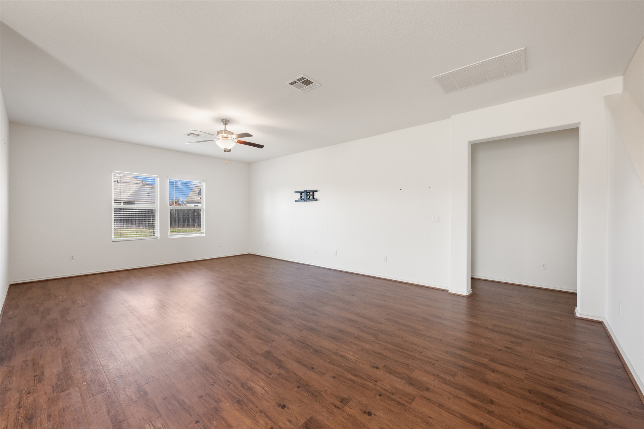 160 Copper Lane Kyle, TX 78640 - Photo 19 of 40 a view of an empty room with wooden floor and a window
