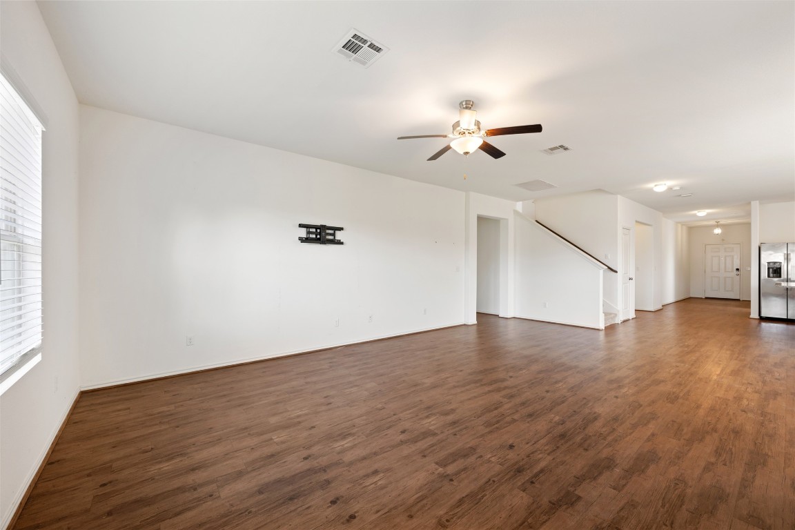 160 Copper Lane Kyle, TX 78640 - Photo 21 of 40 a view of a room with wooden floor and ceiling fan