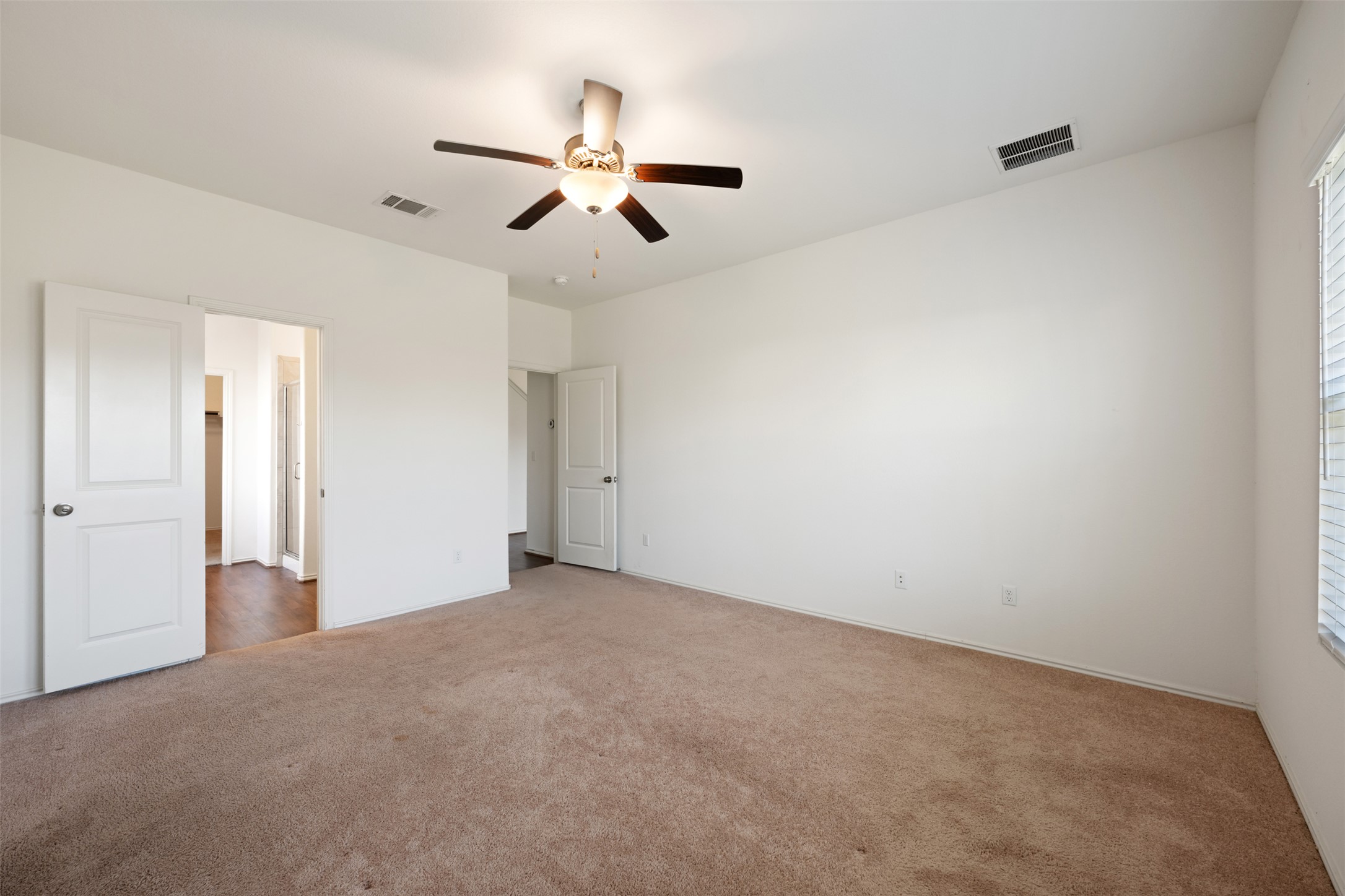 160 Copper Lane Kyle, TX 78640 - Photo 23 of 40 a view of an empty room and chandelier fan