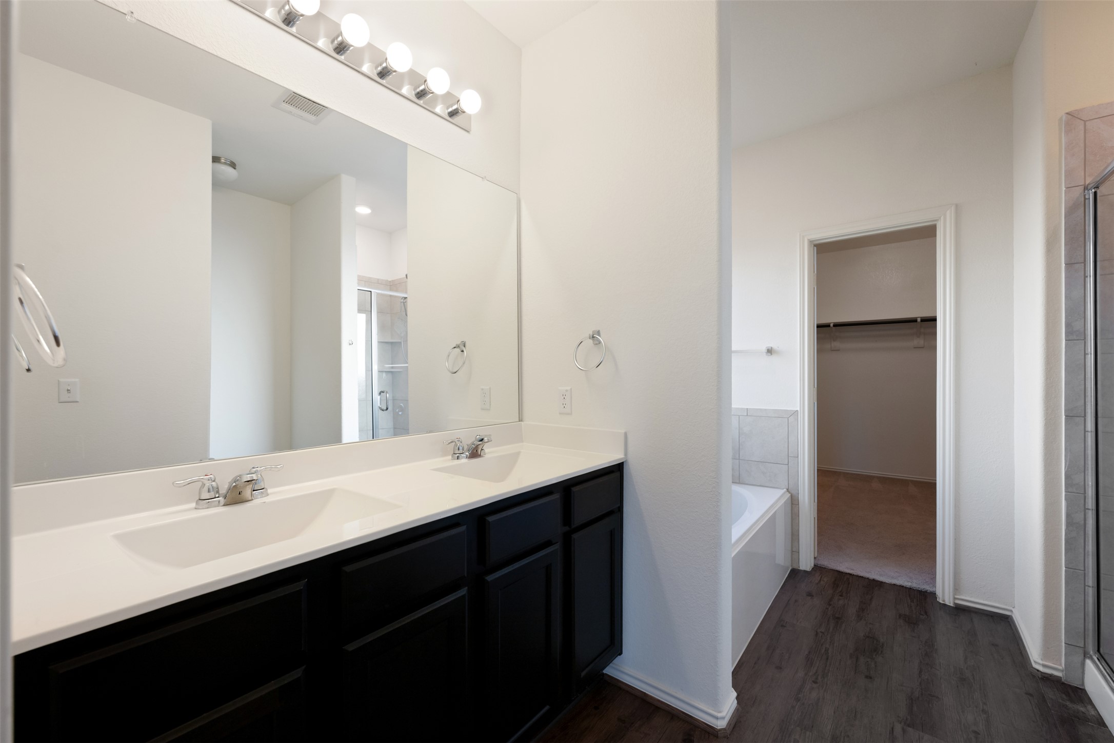 160 Copper Lane Kyle, TX 78640 - Photo 25 of 40 a bathroom with a double vanity sink a mirror and a shower