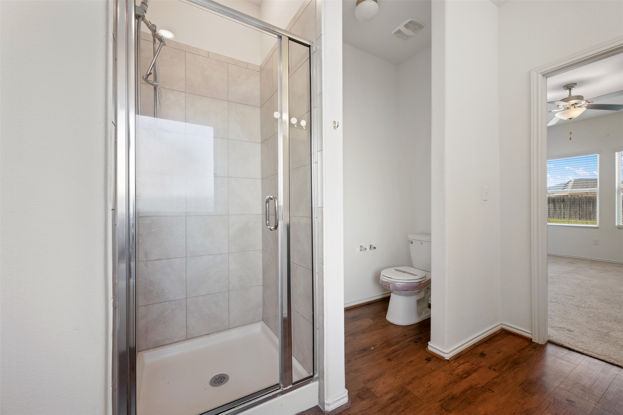 160 Copper Lane Kyle, TX 78640 - Photo 27 of 40 a bathroom view of a toilet and a glass door