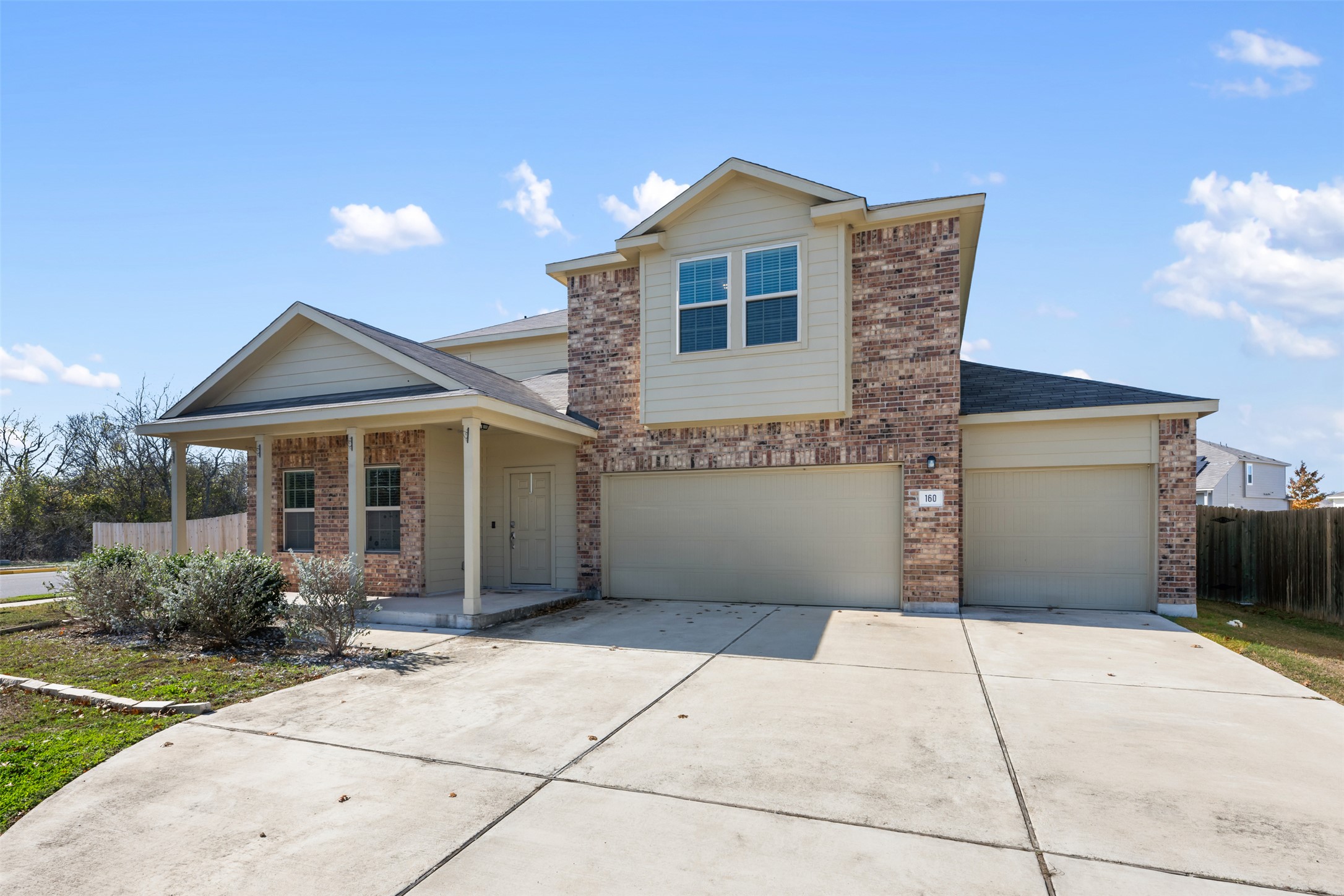 160 Copper Lane Kyle, TX 78640 - Photo 5 of 40 a front view of a house with a garden