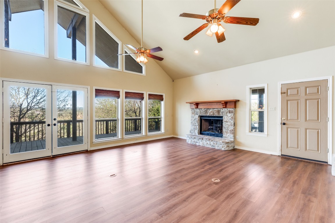 106 Redbud Drive Spicewood, TX 78669 - Photo 11 of 35 a view of an empty room with wooden floor and a window