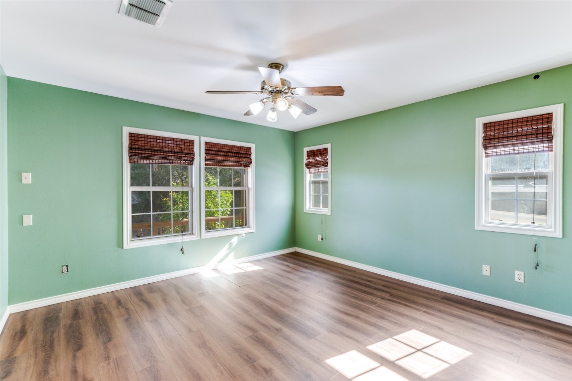 106 Redbud Drive Spicewood, TX 78669 - Photo 14 of 35 a view of an empty room with window and chandelier fan