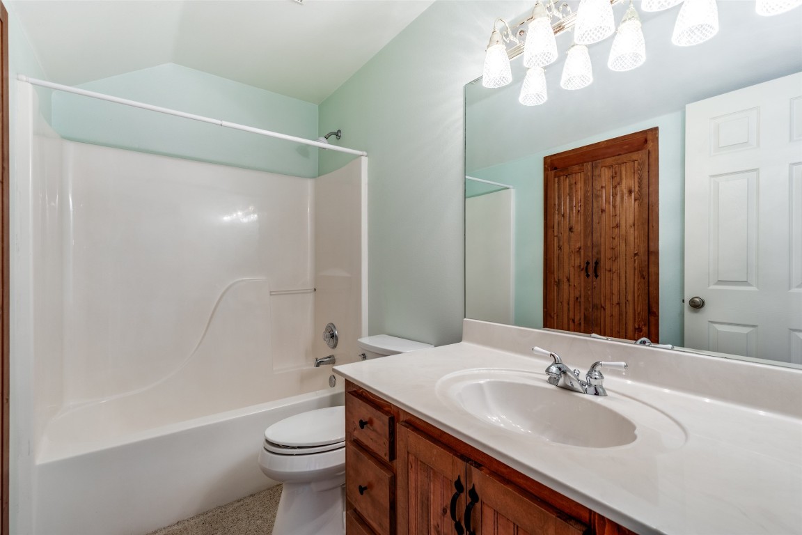 106 Redbud Drive Spicewood, TX 78669 - Photo 17 of 35 a bathroom with a sink a toilet and shower