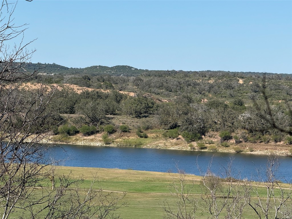 106 Redbud Drive Spicewood, TX 78669 - Photo 26 of 35 a view of a lake with mountain