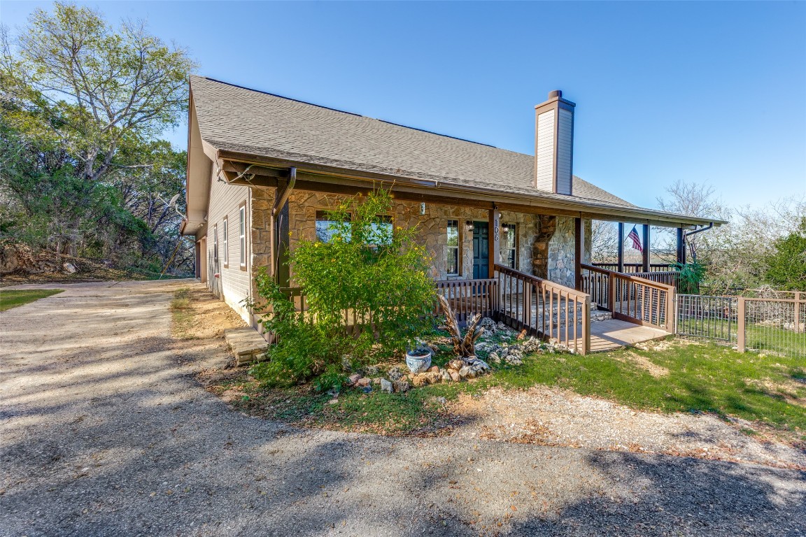 106 Redbud Drive Spicewood, TX 78669 - Photo 3 of 35 a front view of a house with garden