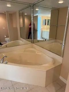 a white toilet sitting next to a shower