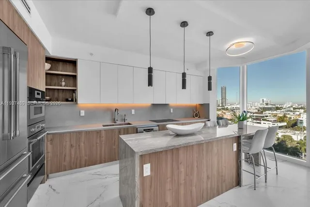 a large kitchen with lots of counter space and furniture