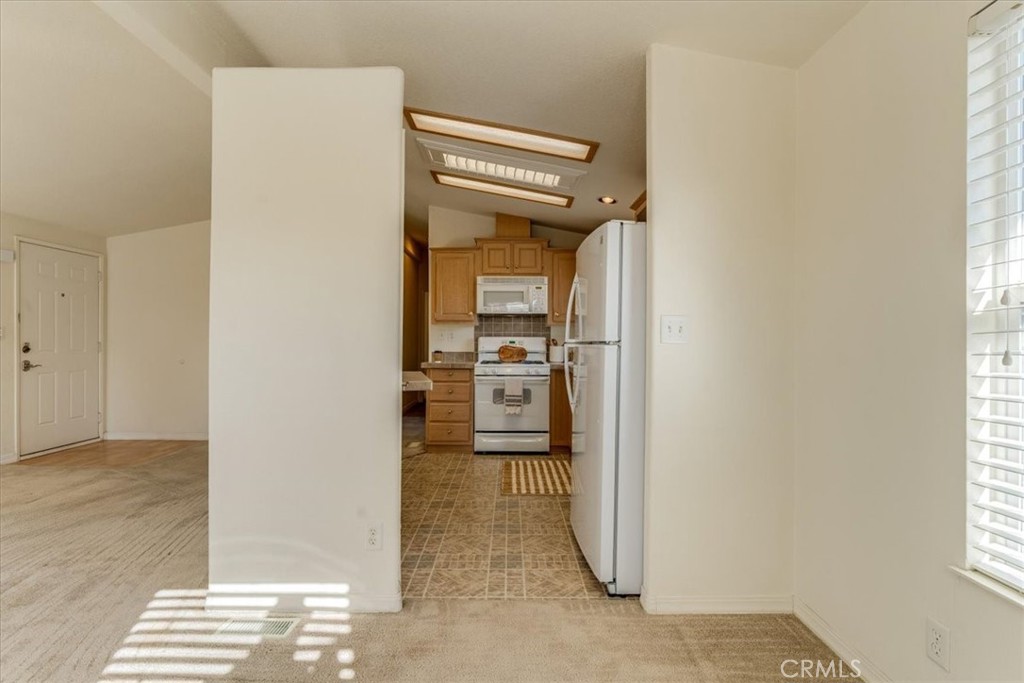 3210 Santa Maria Way, Unit 85 Santa Maria, CA 93455 - Photo 12 of 38 a view of a hallway with wooden floor and a living room
