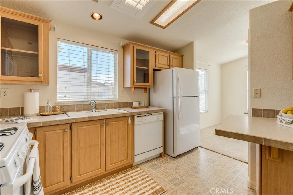 3210 Santa Maria Way, Unit 85 Santa Maria, CA 93455 - Photo 14 of 38 a kitchen with a refrigerator sink and cabinets