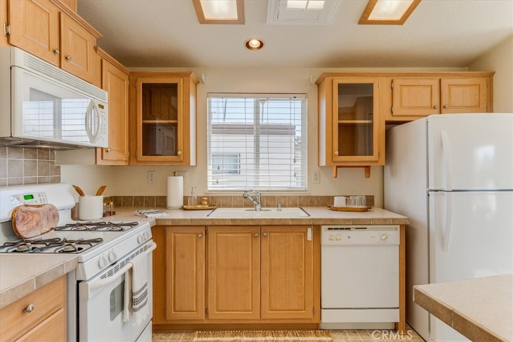 3210 Santa Maria Way, Unit 85 Santa Maria, CA 93455 - Photo 15 of 38 a kitchen with a sink stove and refrigerator