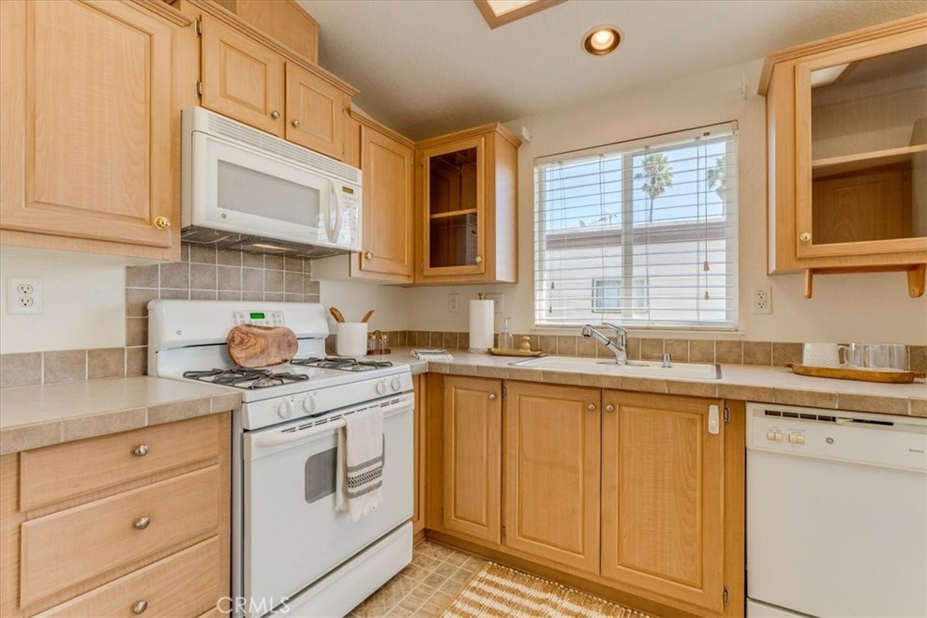 3210 Santa Maria Way, Unit 85 Santa Maria, CA 93455 - Photo 17 of 38 a kitchen with stainless steel appliances granite countertop white cabinets sink and window