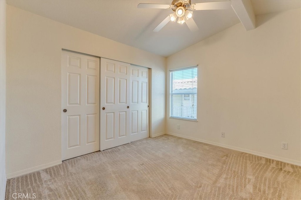 3210 Santa Maria Way, Unit 85 Santa Maria, CA 93455 - Photo 18 of 38 an empty room with chandelier fan and windows