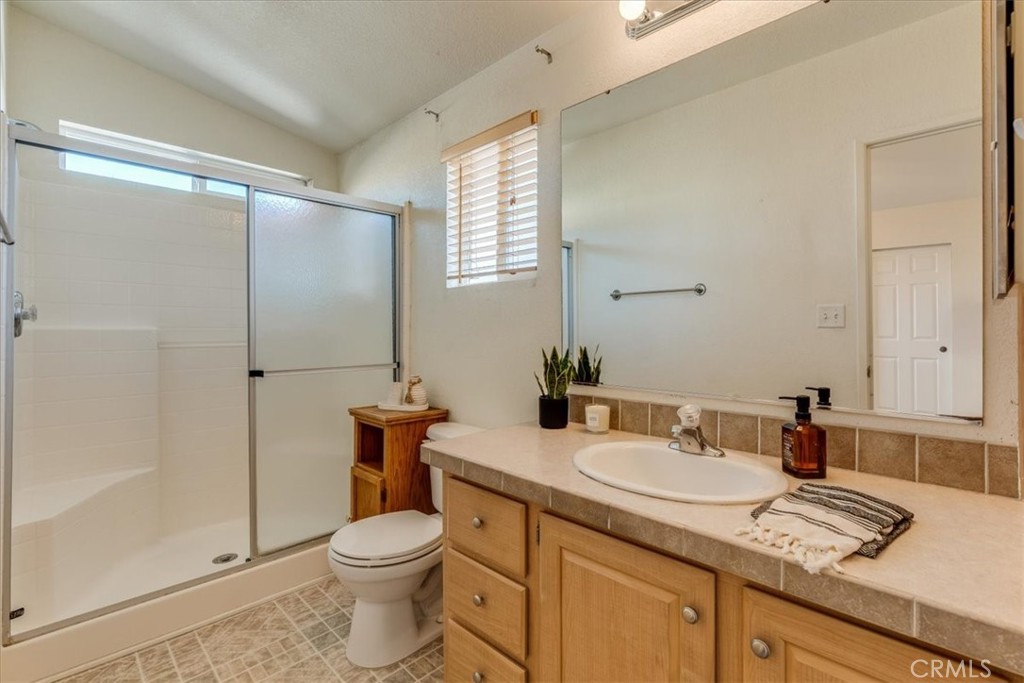 3210 Santa Maria Way, Unit 85 Santa Maria, CA 93455 - Photo 22 of 38 a bathroom with a granite countertop sink toilet and shower