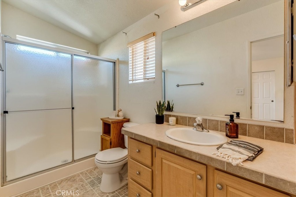 3210 Santa Maria Way, Unit 85 Santa Maria, CA 93455 - Photo 23 of 38 a bathroom with a granite countertop sink toilet and shower