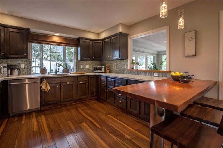 1025 South Rice Road Ojai, CA 93023 - Photo 8 of 17 a kitchen with stainless steel appliances granite countertop a sink a stove and wooden floors